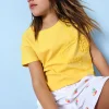 Bermuda in maglia per bambina di colore bianco con motivo floreale.