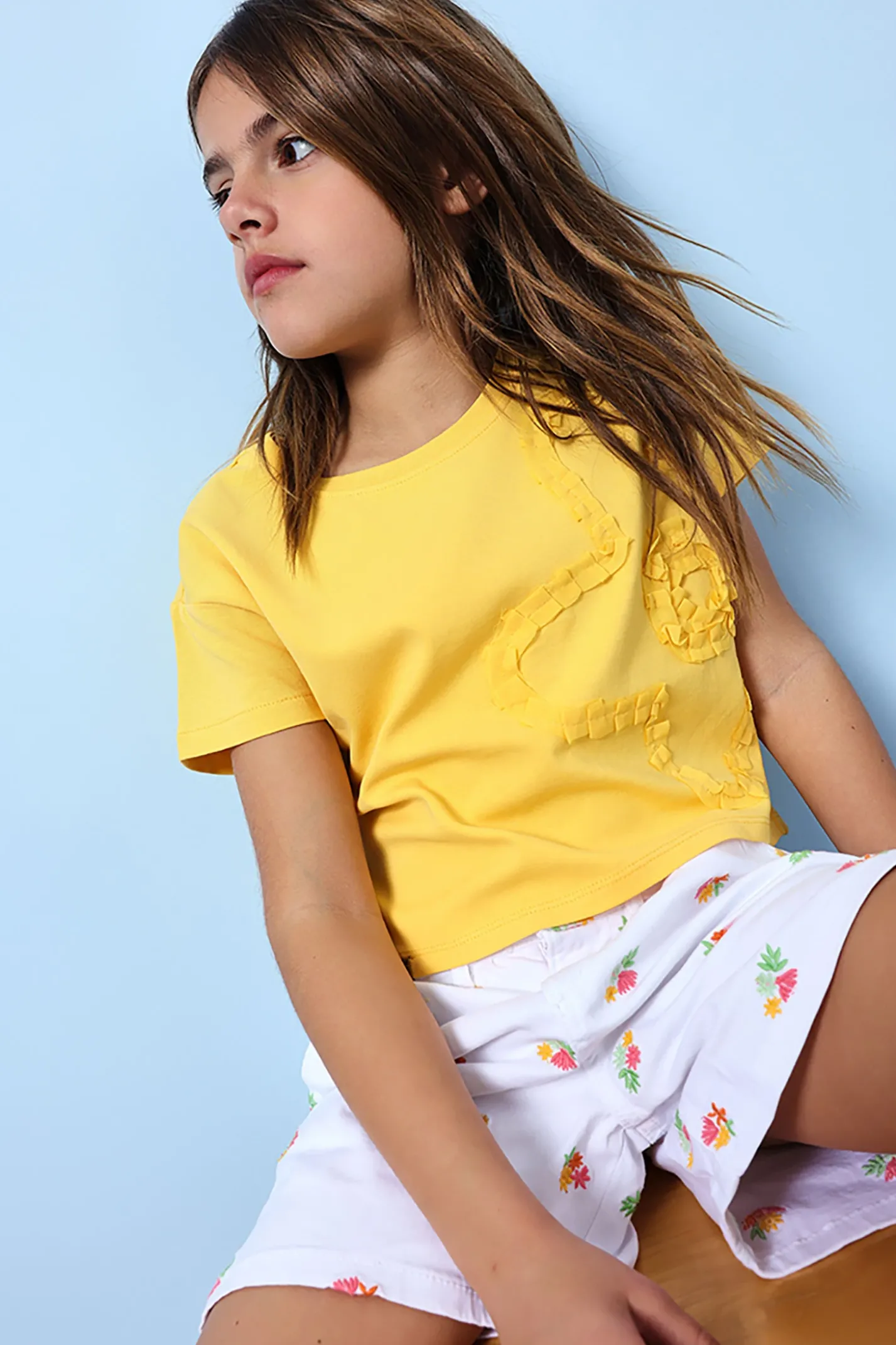 Bermuda in maglia per bambina di colore bianco con motivo floreale.