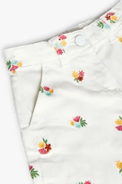 Bermuda in maglia per bambina di colore bianco con motivo floreale.