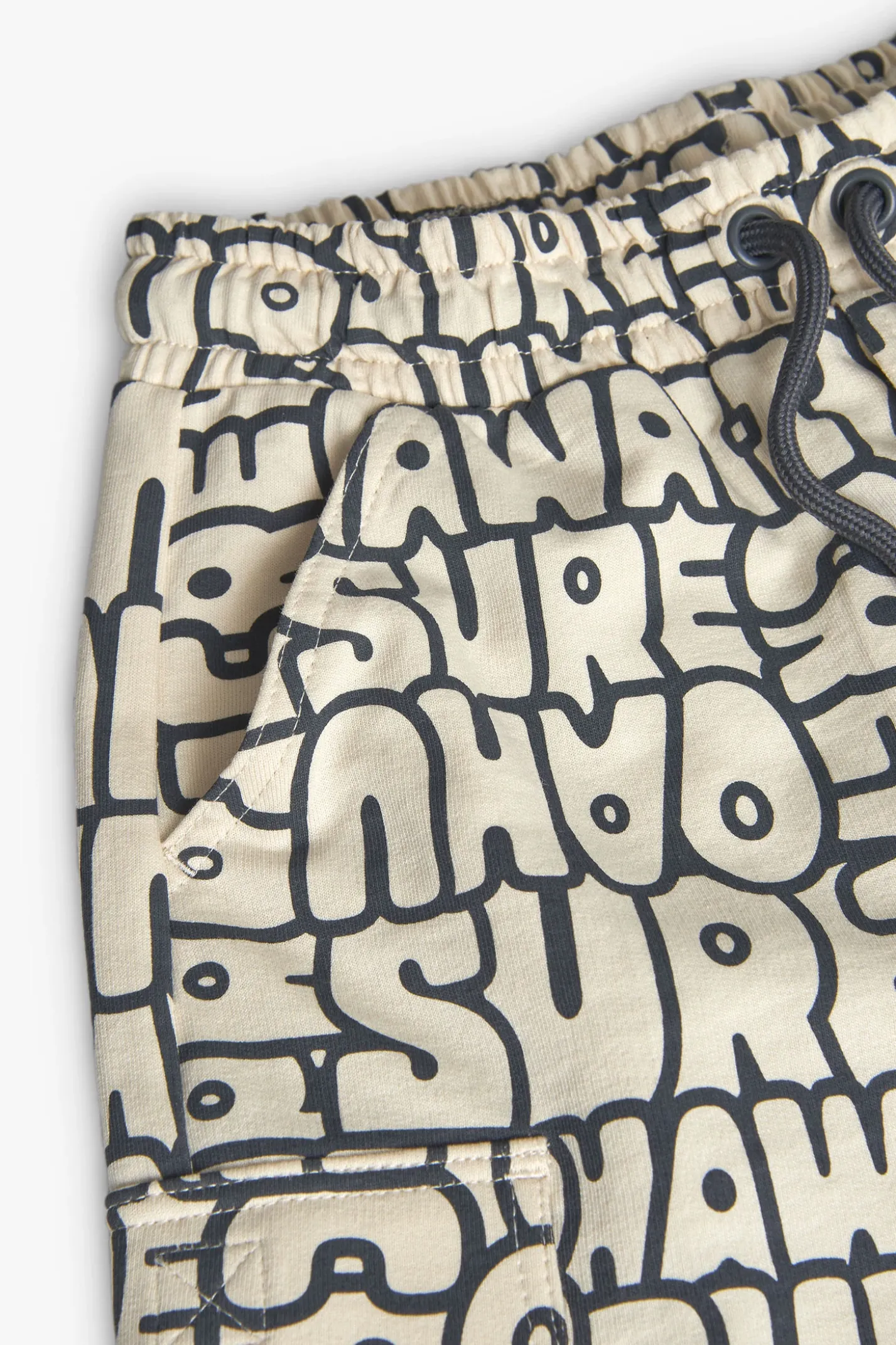 Bermuda in maglia per bambino con stampa in colore crema