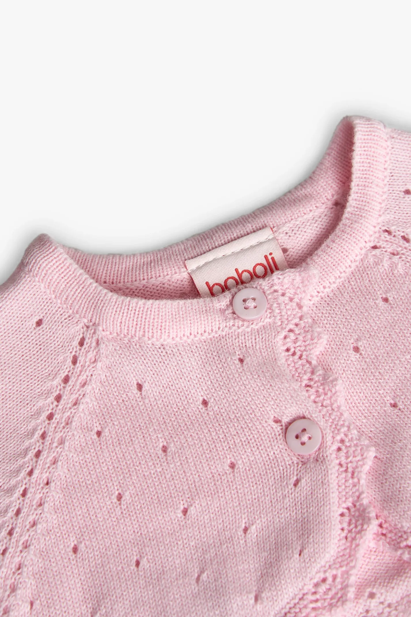 Bolero in maglia per neonata di colore rosa.