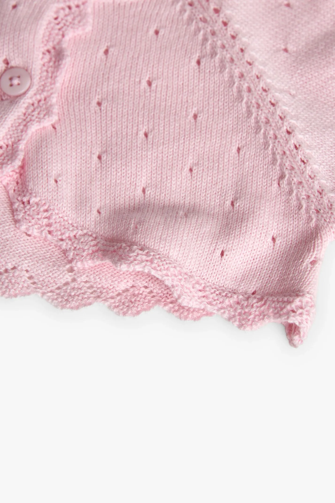 Bolero in maglia per neonata di colore rosa.