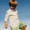 Camicia in popeline per bambini stampata in colore bianco con motivo di dinosauri