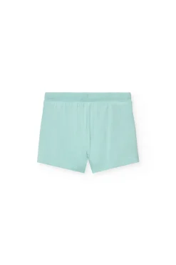 Completo di maglietta e pantaloncini a maglia per neonata di colore bianco.
