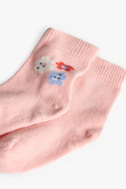 Confezione di calzini a maglia per neonata in colore rosa.