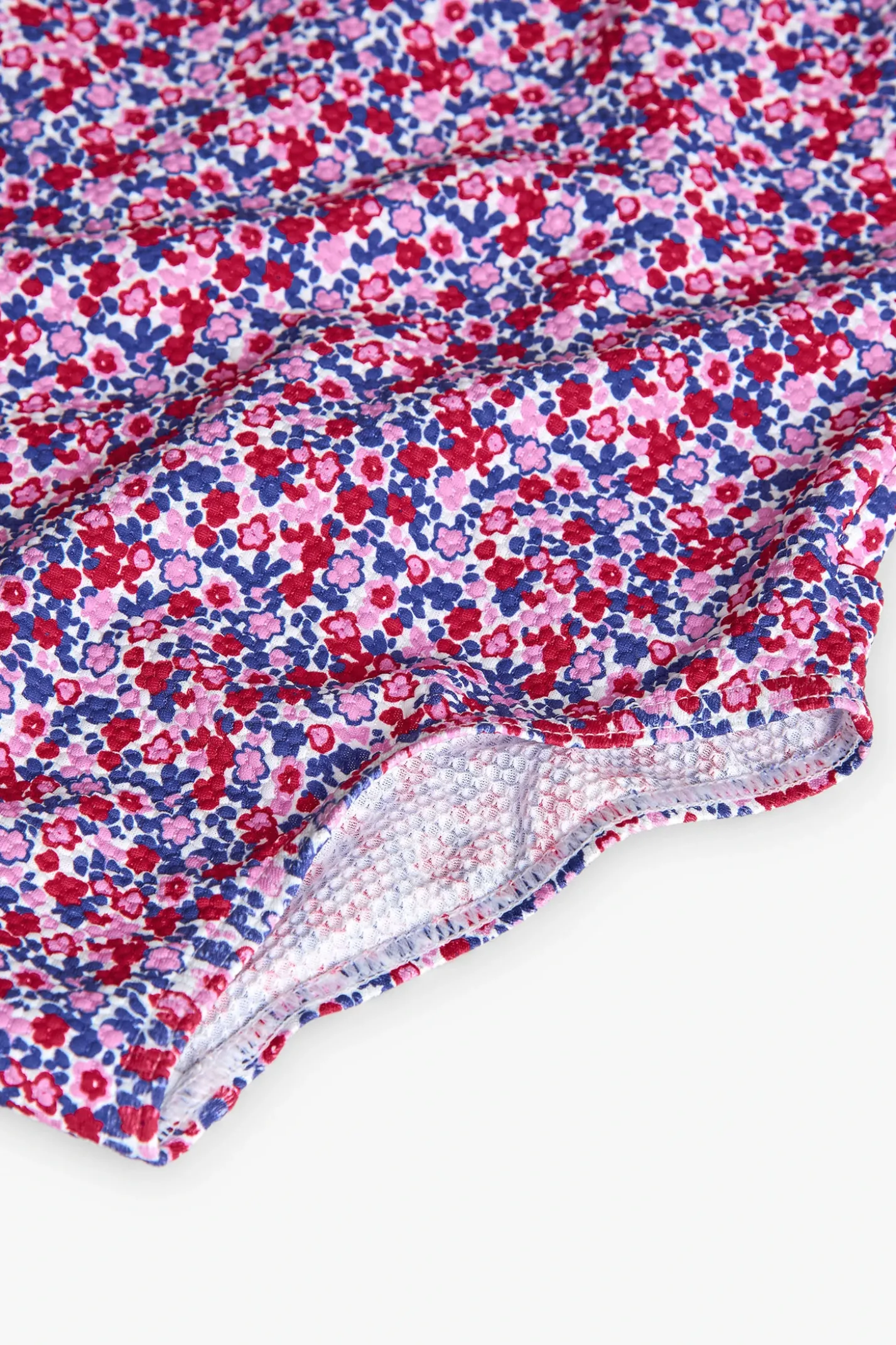 Costume da bagno in poliammide per bambina con stampa floreale in rosa e blu.