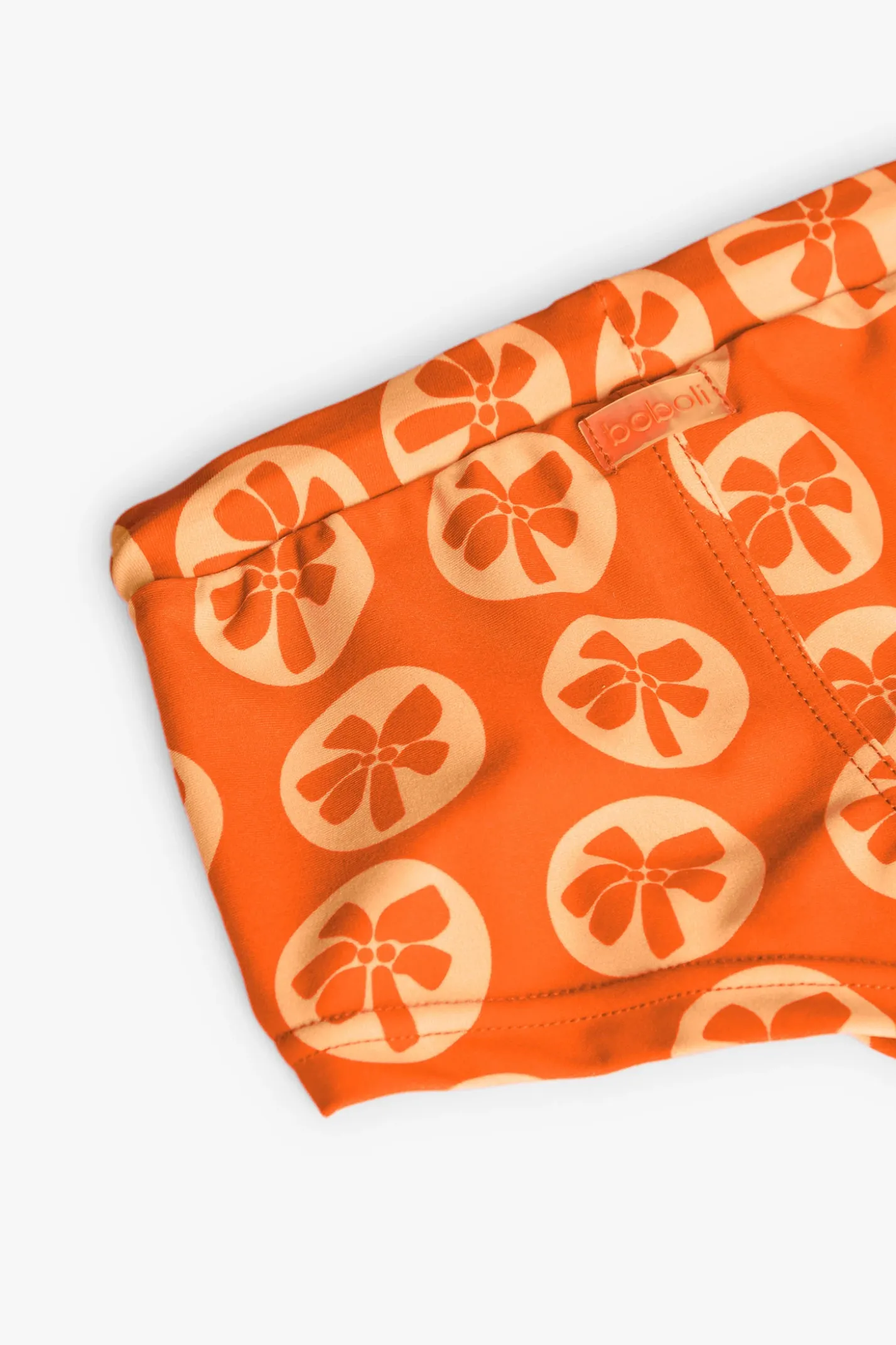 Costume da bagno in poliammide per bambino con stampa di colore arancione.