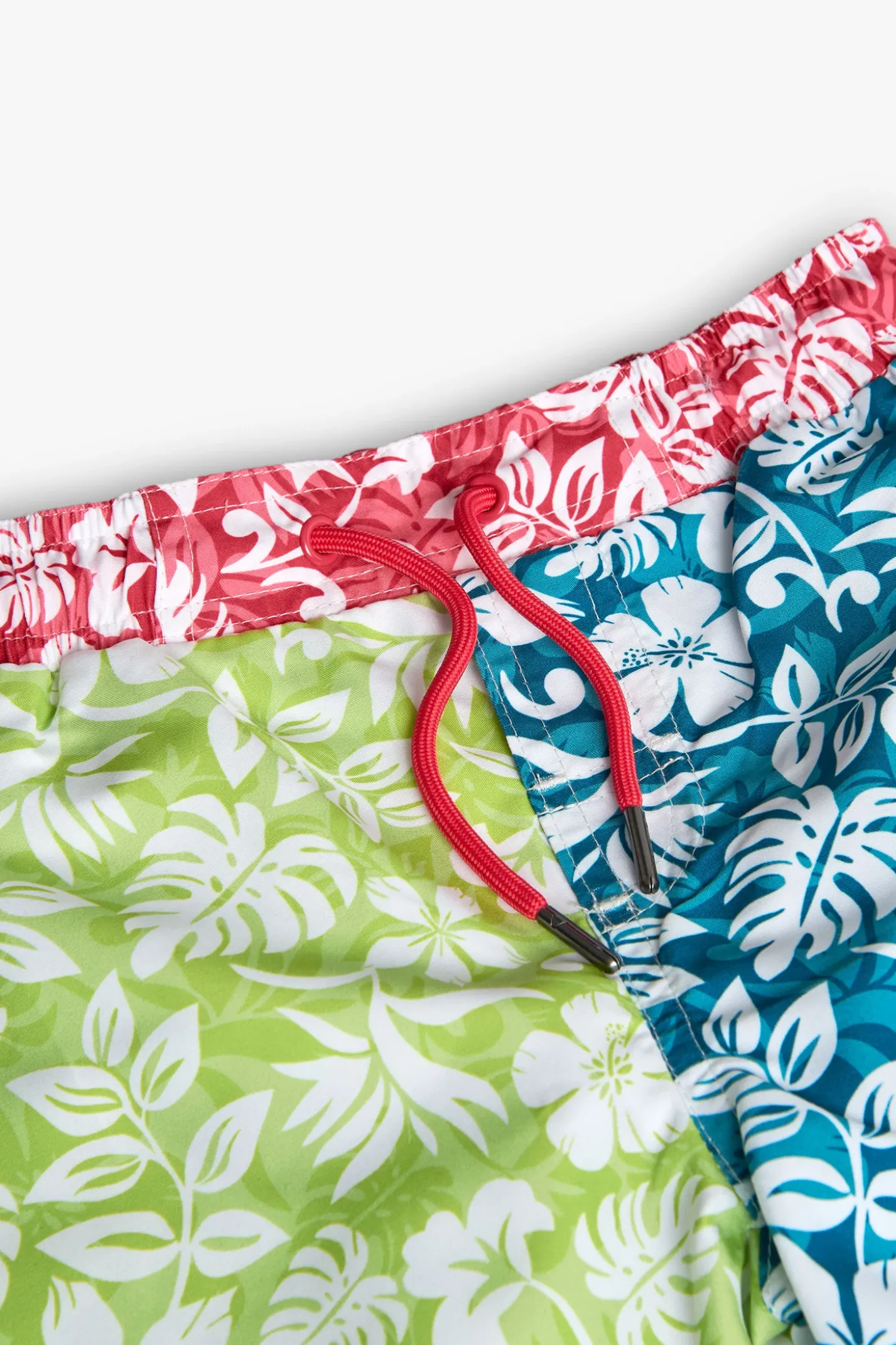 Costume da bagno in tessuto riciclato per bambino di colore verde con motivo floreale.