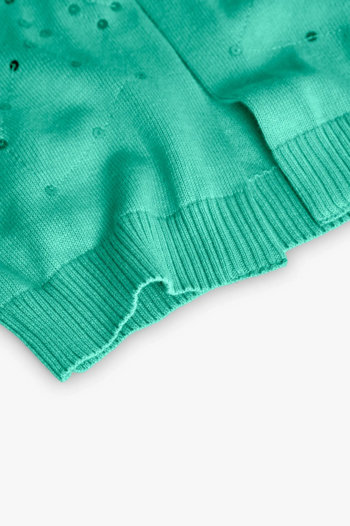 Giacca in maglia per bambina di colore verde con design brillante.