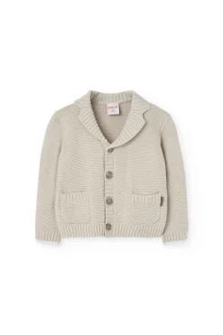 Giacchetta in maglia per neonato di colore beige.