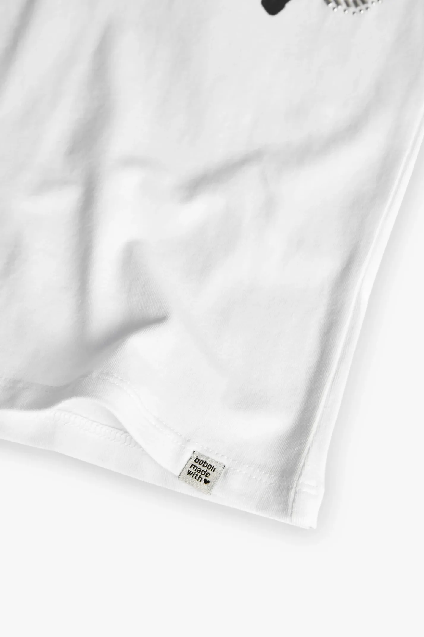 Maglietta di maglia elastica per bambina di colore bianco