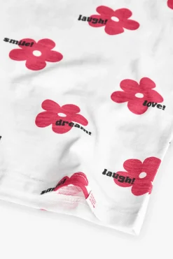 Maglietta in maglia per bambina di colore bianco con stampa floreale.