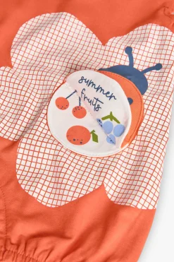 Pagliaccetto in maglia per neonata in colore rosso con design di coccinella.