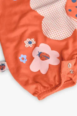 Pagliaccetto in maglia per neonata in colore rosso con design di coccinella.