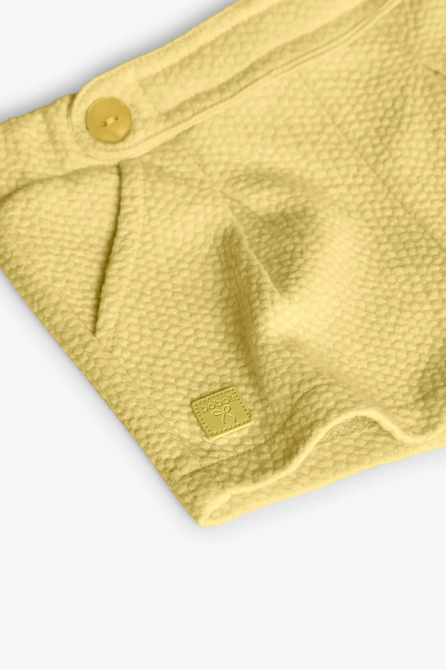 Pantaloncini in maglia per neonata in colore giallo