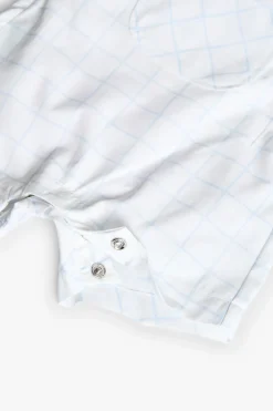 Set da neonato lavorato a maglia in colore bianco con stampa a quadri.