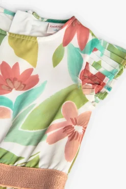 Tuta di chiffon plissettato per bambina con motivo floreale nei colori rosa e verde.