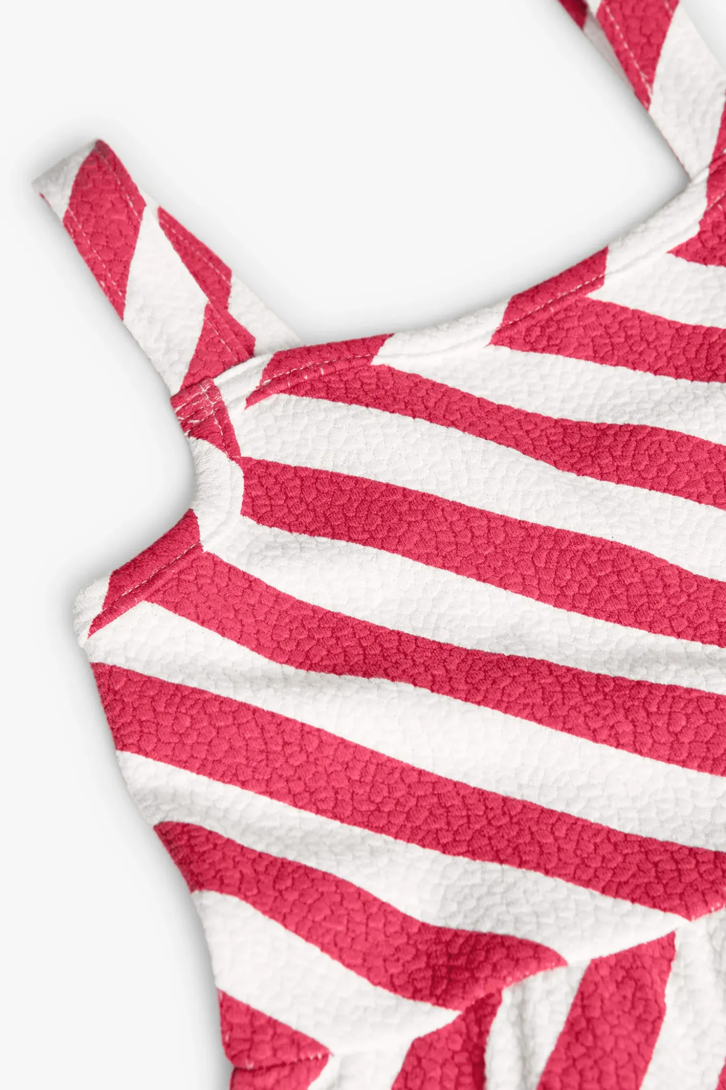 Vestito a maglia per bambina in colore rosso e bianco.