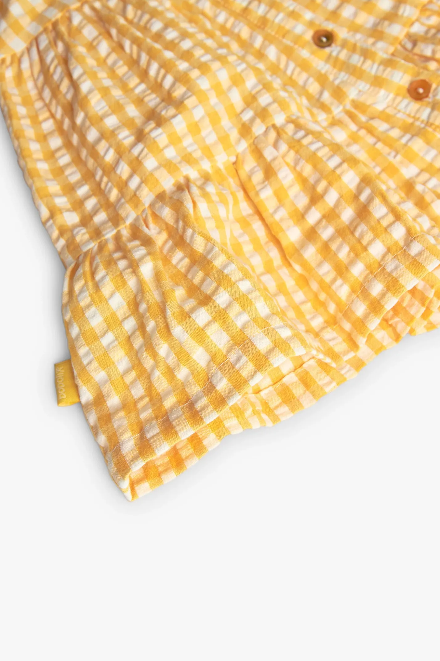 Vestito di popeline per neonata con stampa a quadri di colore giallo.